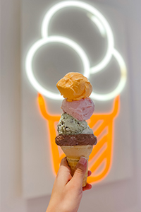 3 scoop ice cream cone help up against fluorescent ice cream light in The Creamery at UT Knoxville.