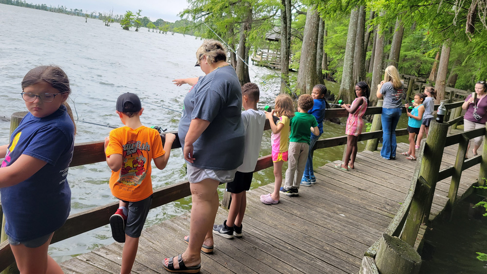 Kids in the Lake County 4-H program fish off a walkway at Reelfoot Lake.