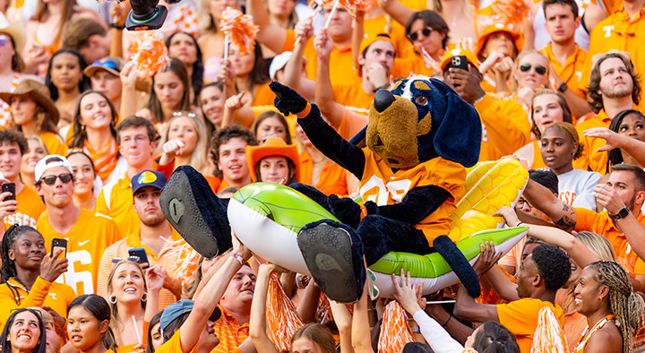UTK Smoky mascot crowd surfs atop a pool inflatable.