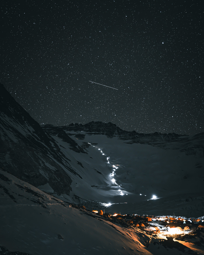 A starry night at Camp II with the headlamps of climbers as they begin their ascents to Camp III and higher with the Lhotse face and Lhotse summit in the background.