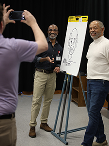 Left to right, guest speaker Don Tate poses for a photo with conference attendee Scott Gaines during an illustration demonstration.