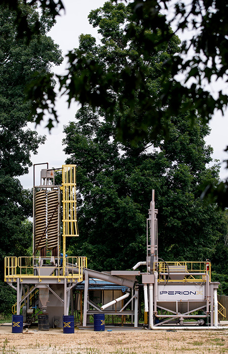 A mineral separation facility with trees in the background.