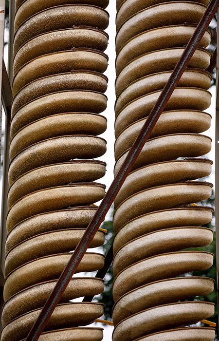 Two stacks of metal coils designed to filter out minerals from sand.