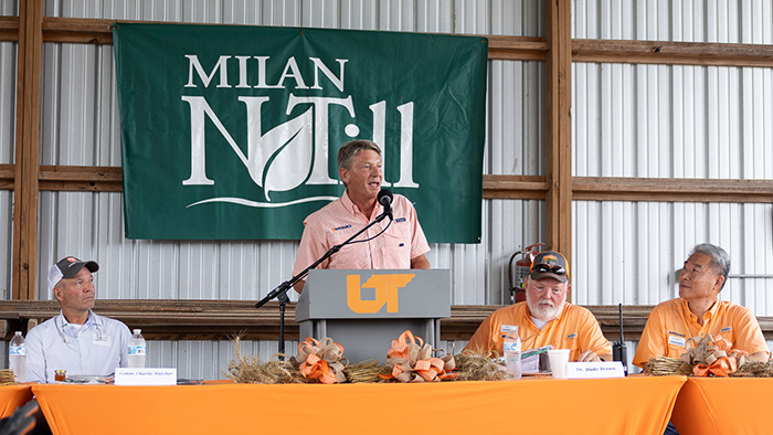 UT President Randy Boyd, Tennessee Commissioner of Agriculture Charlie Hatcher, director Blake Brown and UT AgResearch Dean Hongwei Xin, sitting at an orange table speaking to guests at Milan.