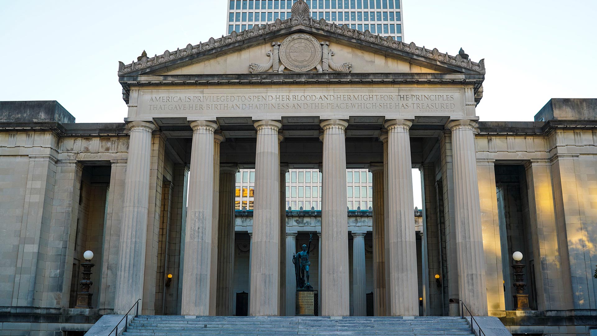 A historic building with columns with the quote "America is privileged to spend her blood and her might for the principles that gave her birth and happiness and the peace which she has treasured."