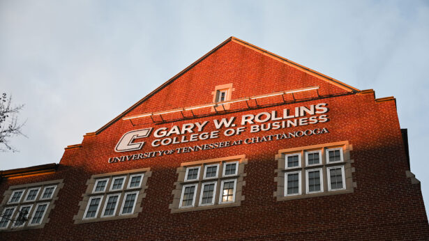 A red brick building lit up by the sunset.