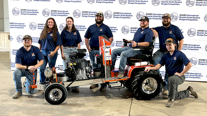 A team stands by their tractor during a competition.