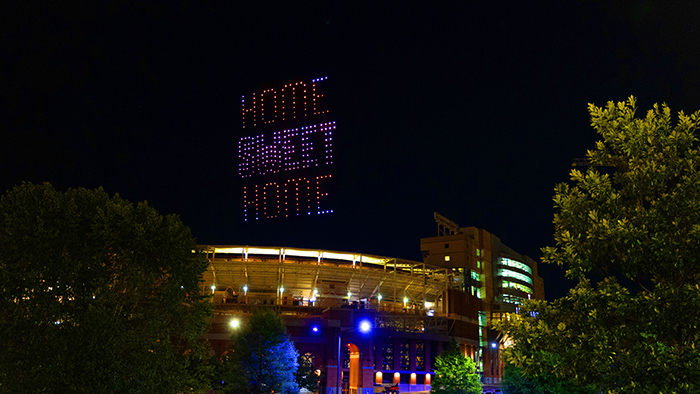 Neyland stadium lit up at night with colorful lights.