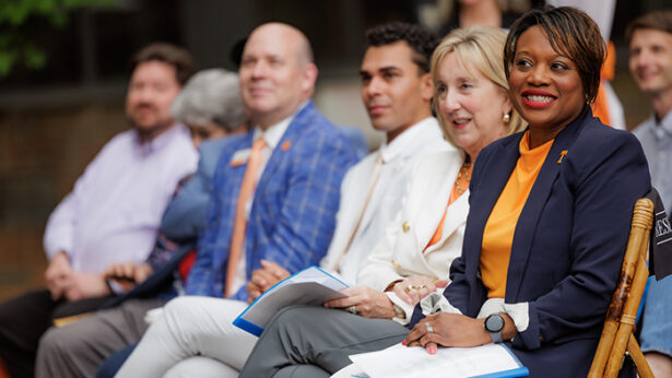People sitting during a building groundbreaking ceremony.