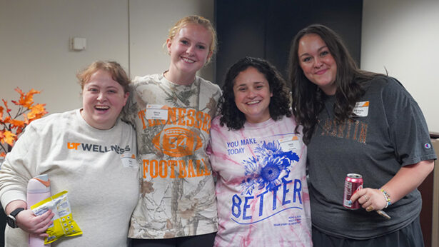 Four women standing together for a photo.