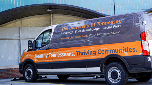 A mobile health van with clinic details on the vehicle wrap.
