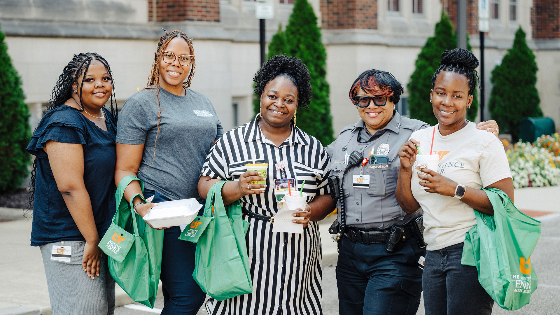 A group of women standing together, smiling for a photo.