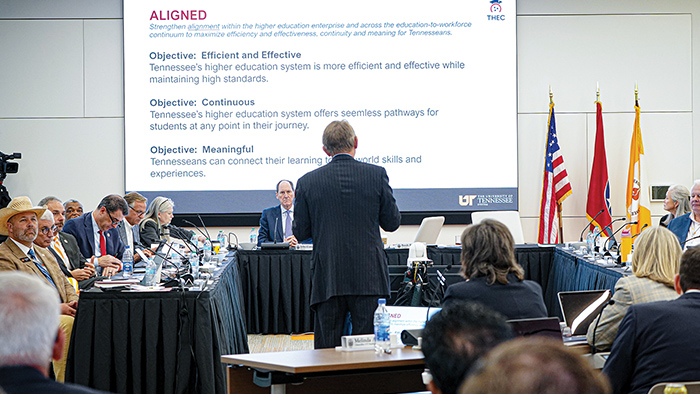 A man presenting before a room of board members.