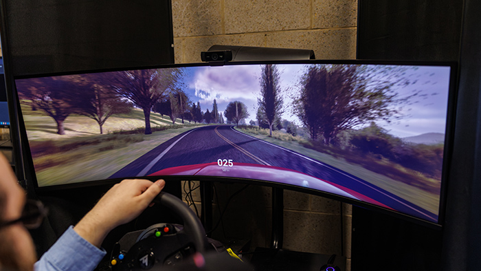 A person operating a driving simulator on a computer.