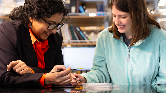 Two women examining tissue samples.