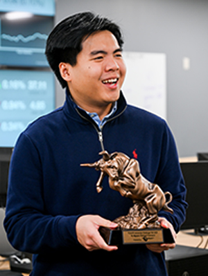 A person holding an award.