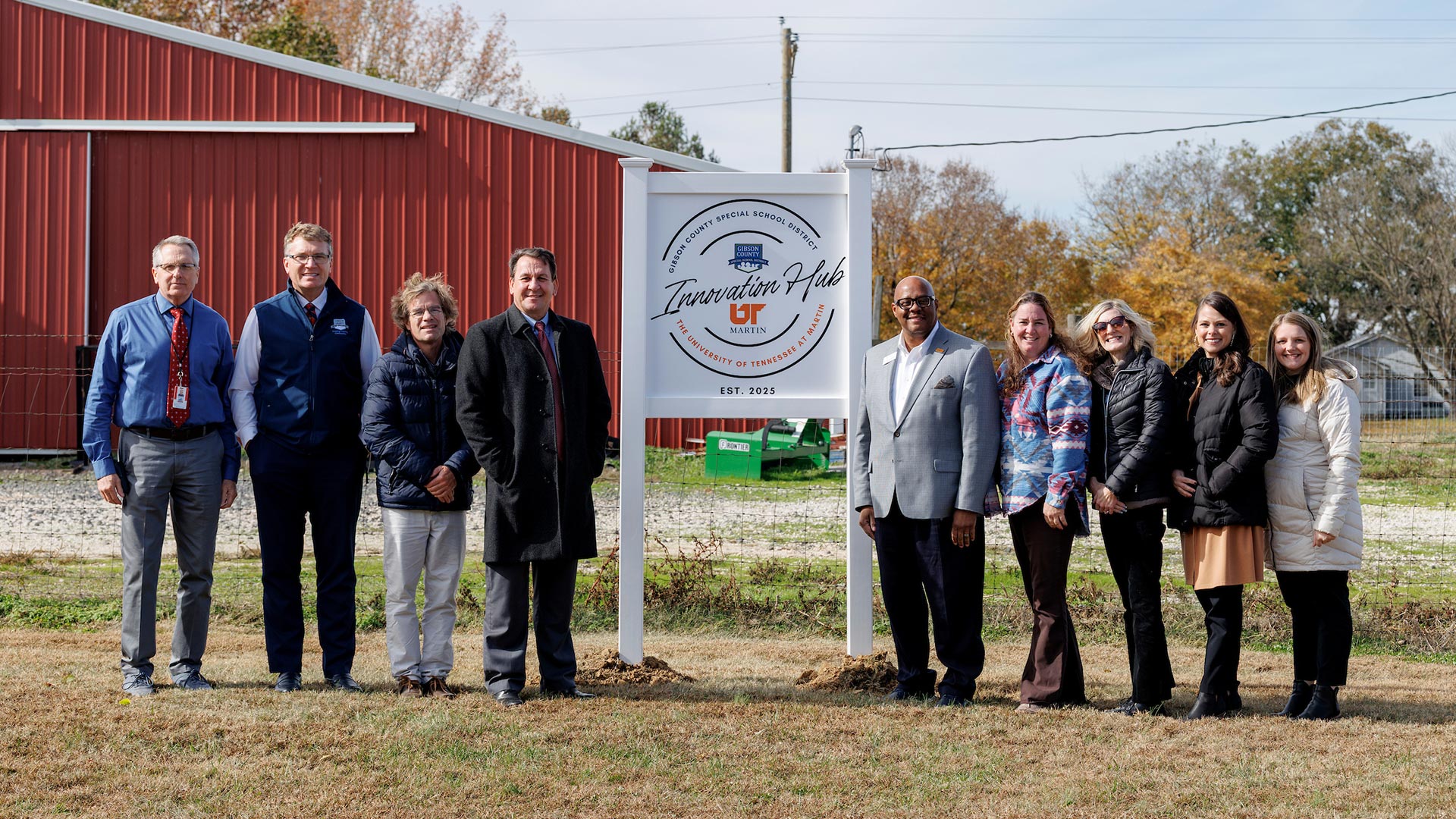 A group of people standing next to a sign that says "Innovation Hub."