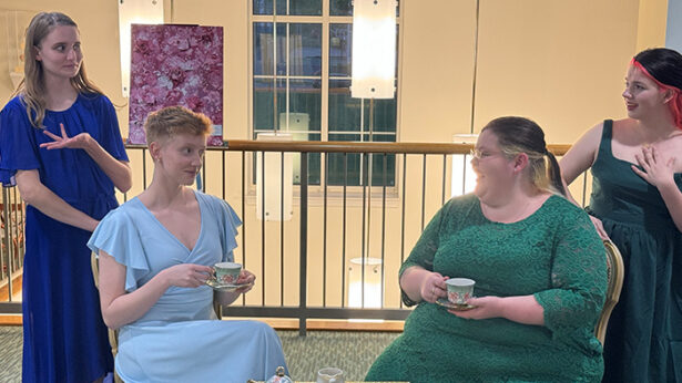 Four students acting in a play.