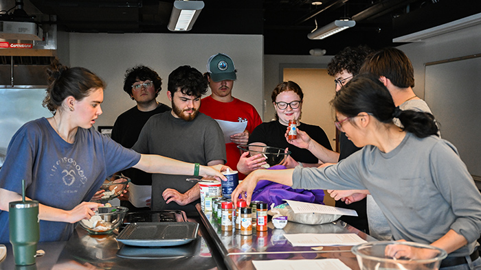 A group of students working together in a kitchen.
