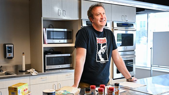 Man talks while in a kitchen.