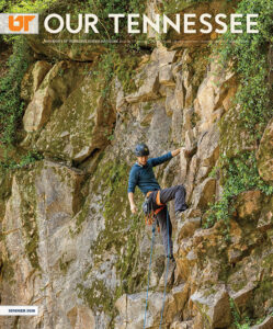 Man in safety gear climbing a cliff face.