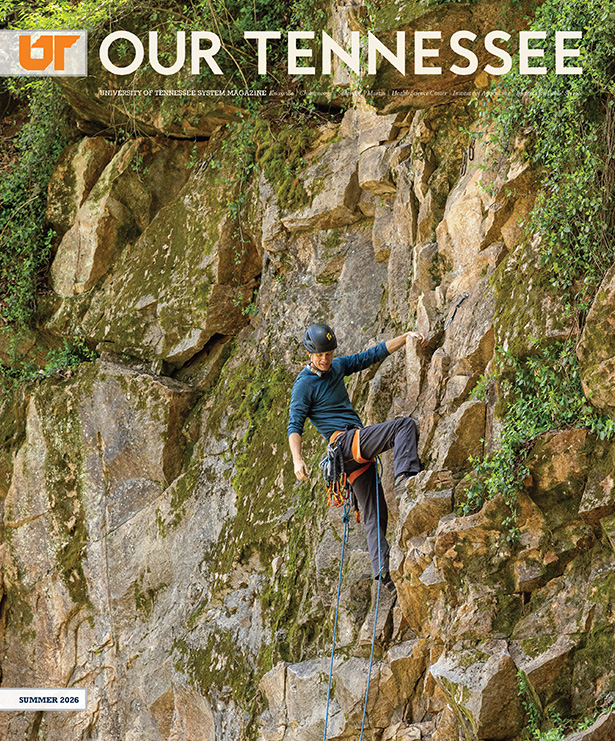 Man in safety gear climbing a cliff face.