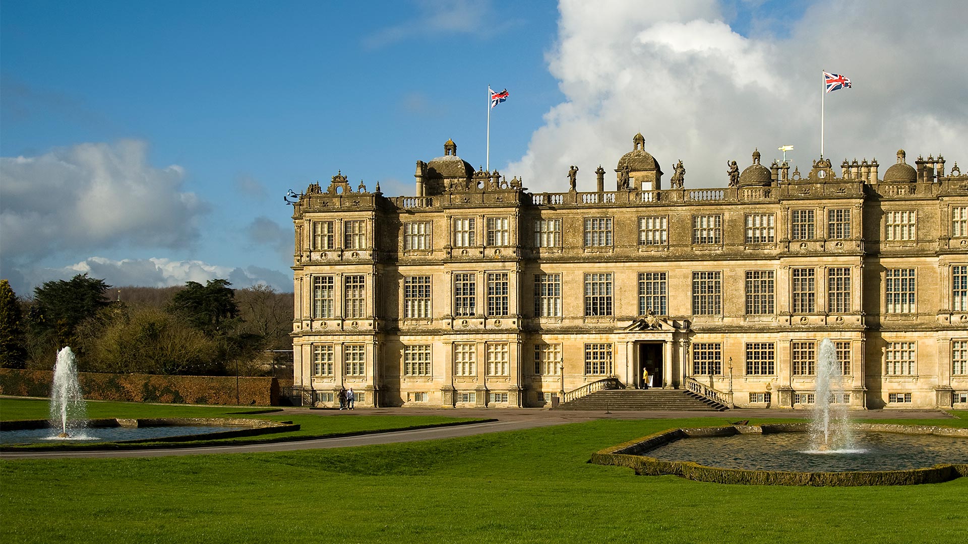 An old English estate and water fountains.