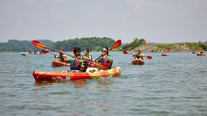 A group of kayakers on the water.
