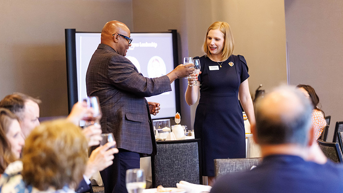 Two people making a toast during a ceremony.