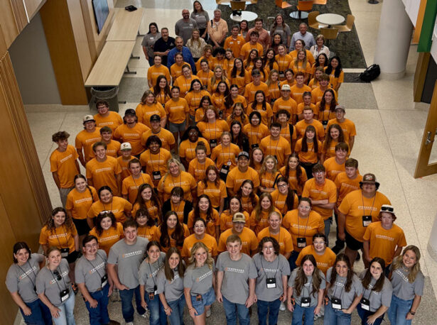 A large group of high school students posing for a photo from above.