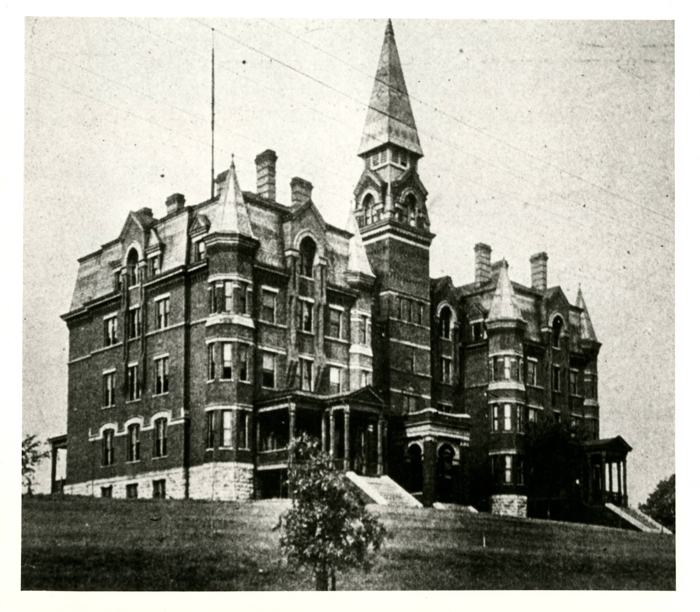 Scanned, historic photo of an old brick building.